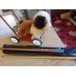 snooker cue in material case and retro push along dog