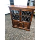 Oak 2 door lead glazed bookcase with cupboard below ( missing one piece of glass ) 33 inches wide 10