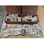 collection of cigarette cards in 2 wooden boxes