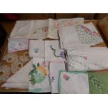 collection of embroided linens and ladies scarfs
