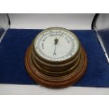 Vintage Brass Ships Barometer on oak plinth. Glass cracked and brass casing cracked. 7 inches wide