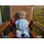 A vintage composite bisque faced doll, by Kammer + Reinhartd marked '126 Simon & Halbig' with