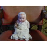 A composite bisque faced 1920's era Armand Marseille doll articulated limbs and blue sleepy eyes