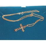 9ct chain with yellow metal crucifix set with dark red stones ( chain approx 4 grams )