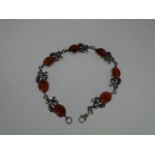 A white metal 'Amber' bracelet, 20cm with grape vine decoration.