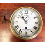 A ships brass bulkhead clock, the white painted dial with seconds dial signed 'Lilley & Reynolds Ltd
