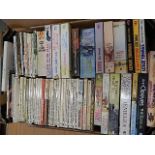 2 boxes of books to include cowboy novels and modern novels, few cook books