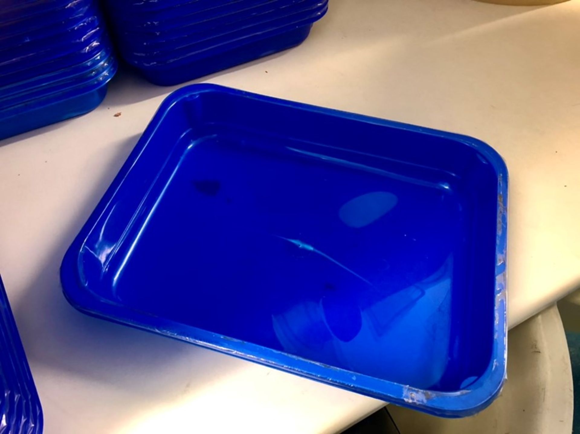 Approximately 230 small blue product trays
