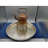 A copper kettle with a brass stand and a metal tray