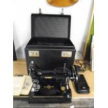 Singer sewing machine no. 221k in case with original instruction manuals