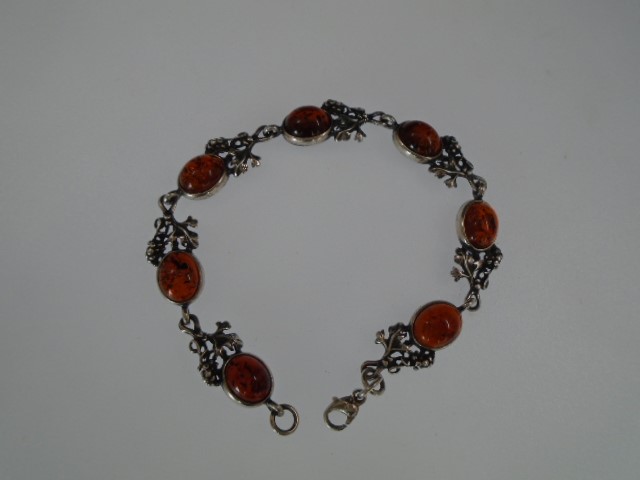 A white metal 'Amber' bracelet, 20cm with grape vine decoration.