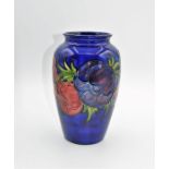 An early twentieth century Moorcroft vase decorated with flowers. overall in good condition signed