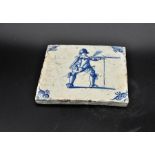 Dutch Delftware blue on white tin glazed tile c. 1690, depicts a musketeer discharging his weapon