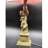 Table lamp, sculptured cherub holding a vase signed C Paul 37cm tall