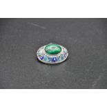 Chinese? sterling silver brooch, ovoid in form set with a central cabochon of malachite and a