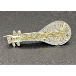 Continental sterling silver brooch in the form of a four-string mandolin, filigree scrollwork to