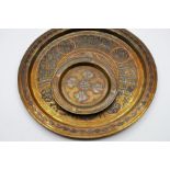 decorative plate with Persian Islamic pattern engraving to the plate with smaller Persian brass