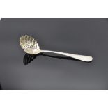 English sterling silver sugar sifting spoon with gilt openwork scallop shell-shaped bowl,