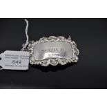 Silver decanter label, traditional repousse shell and foliate border, engraved "Scotch" 13 grams