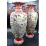 A pair of Japanese Satsuma vases, height 46cm, some historic repair of damage to one vase is evident