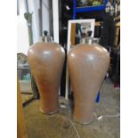 A pair of very large lamp bases 43" tall in a brown/ light terracotta colour with glazed effect,