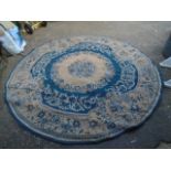 Blue patterned round rug 8ft across, has a rip