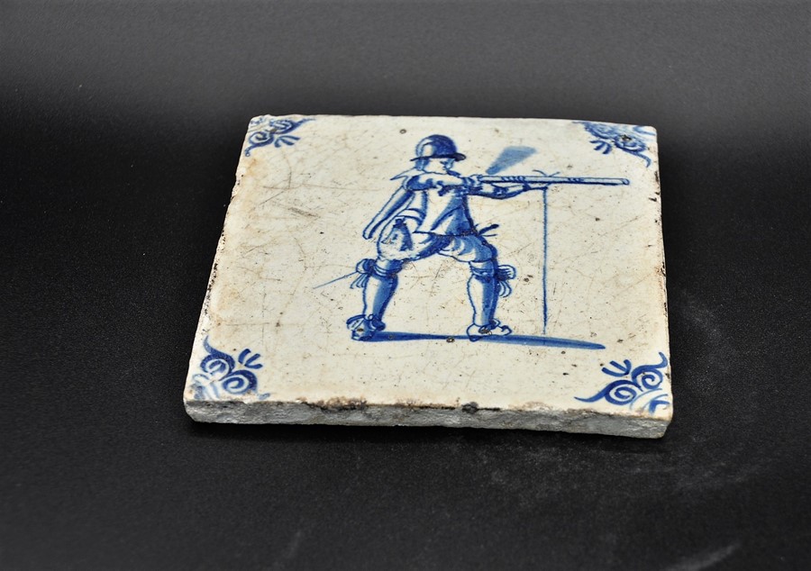 Dutch Delftware blue on white tin glazed tile c. 1690, depicts a musketeer discharging his weapon