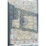 A Persian Nain hand knotted signed wool/silk blend pile rug. With a fine patterned central field