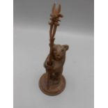 Black Forest Style Bear holding carved stick bear is 5 inches tall