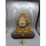 Victorian gilt clock in dome with key.