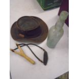 leather country hat, catapult and vintage bottle