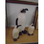 set of ceramic penguins, tallest is 18" tall and the two babies are 10" tall