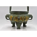 A Chinese Verdigris Patinated Bronze two-handled Sensor with dragon heads on tri-form feet, 19cm