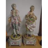 Pair of continental porcelain figurines standing on a plinth. overall height 27"