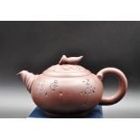 A Chinese Yixing terracotta teapot, H. 10cm, L. 19cm.