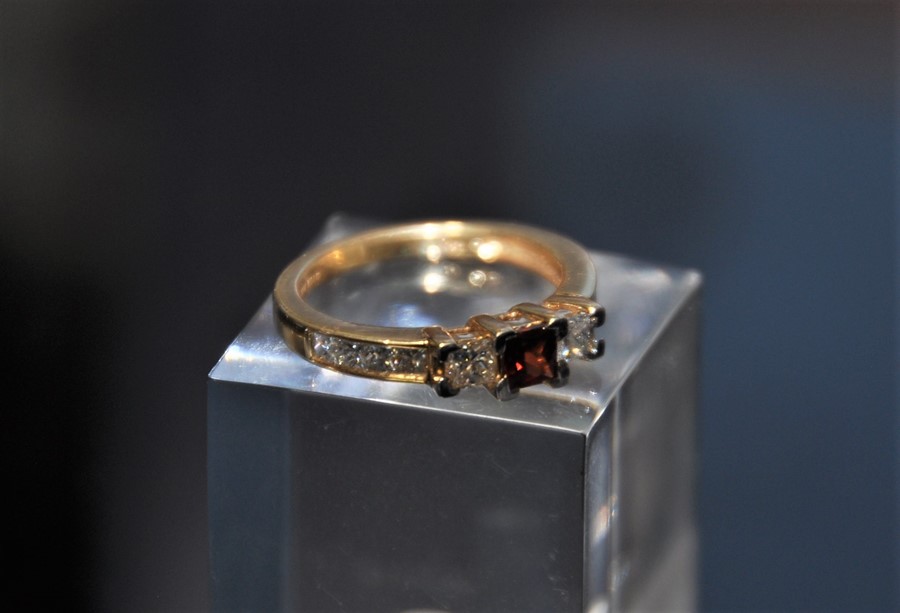 An 18ct gold ruby and diamond ring. 3.7g size N