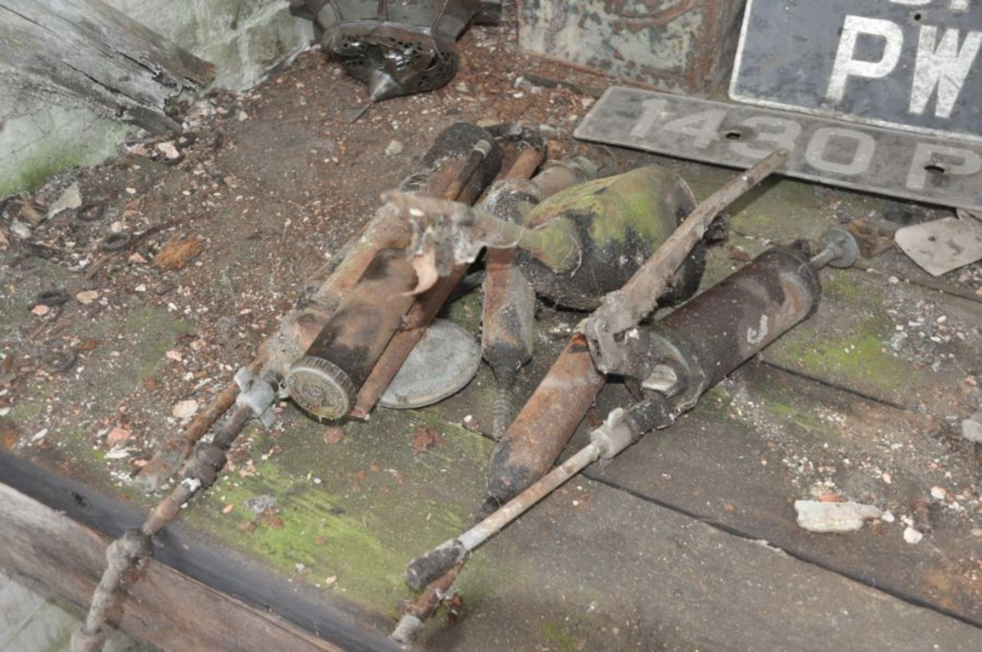 Box of vintage grease guns and oil pumps