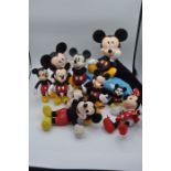 collection of Mickey and Minnie mouse toys/ figures and a Mickey Mouse towel