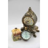 A novelty pepper pot in the form of a small cottage, quartz mantel clock and a globe pocket watch