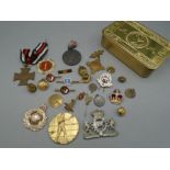 Tin of medals, lapel pins, brooches etc
