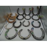 Quantity of horse shoes, some decorated with greetings