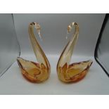 A pair of amber glass swans