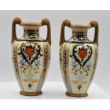 NORITAKE; a pair of twin handled hand painted vases, decorated with floral sprays inside jewelled