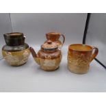Early Doulton stoneware jugs and teapot plus one in similar style, all as found