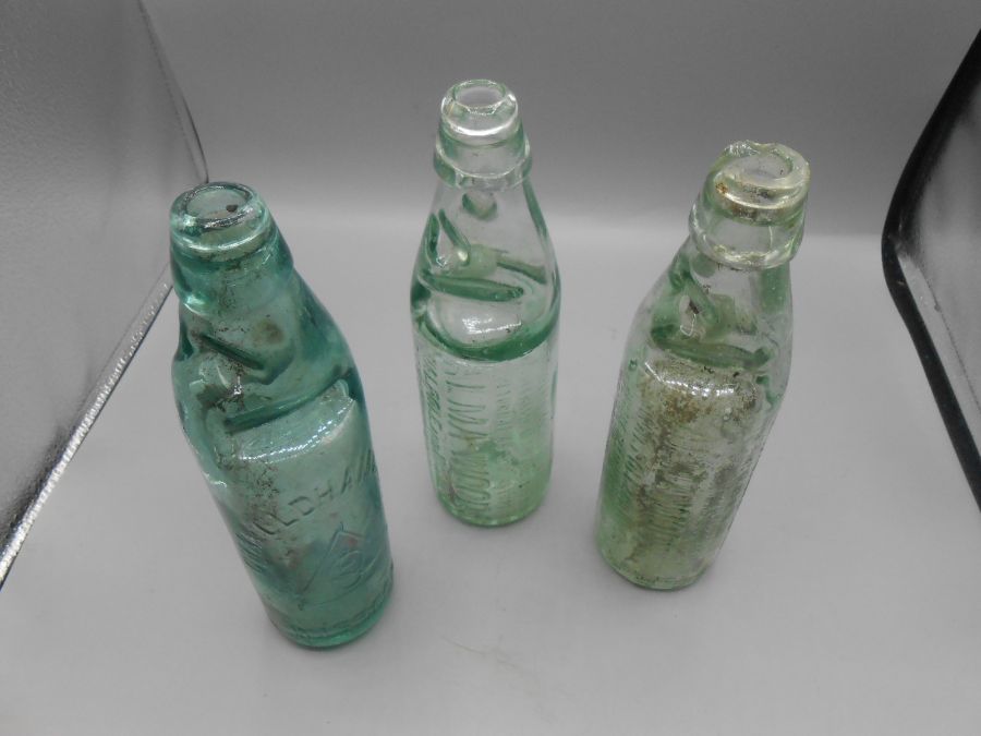 2 Alma Woods Walpole and Wisbech Codd bottles ( one chipped at neck ) and Chas Oldham Wisbech Codd