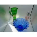 A green glass water jug 32 cm tall, a cocktail shaker with star pattern and a blue glass bowl 26