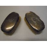 2 silver backed brushes with the initials F.D inscribed.