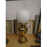 Brass base oil lamp with white globe shade