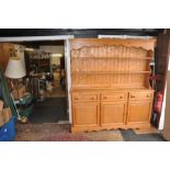 Contemporary pine dresser of large proportions having an open plate rack above sideboard with 3