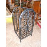 Black metal wine rack with ornate doors